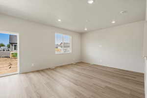 Unfurnished room featuring light wood-type flooring, recessed lighting, and a textured ceiling