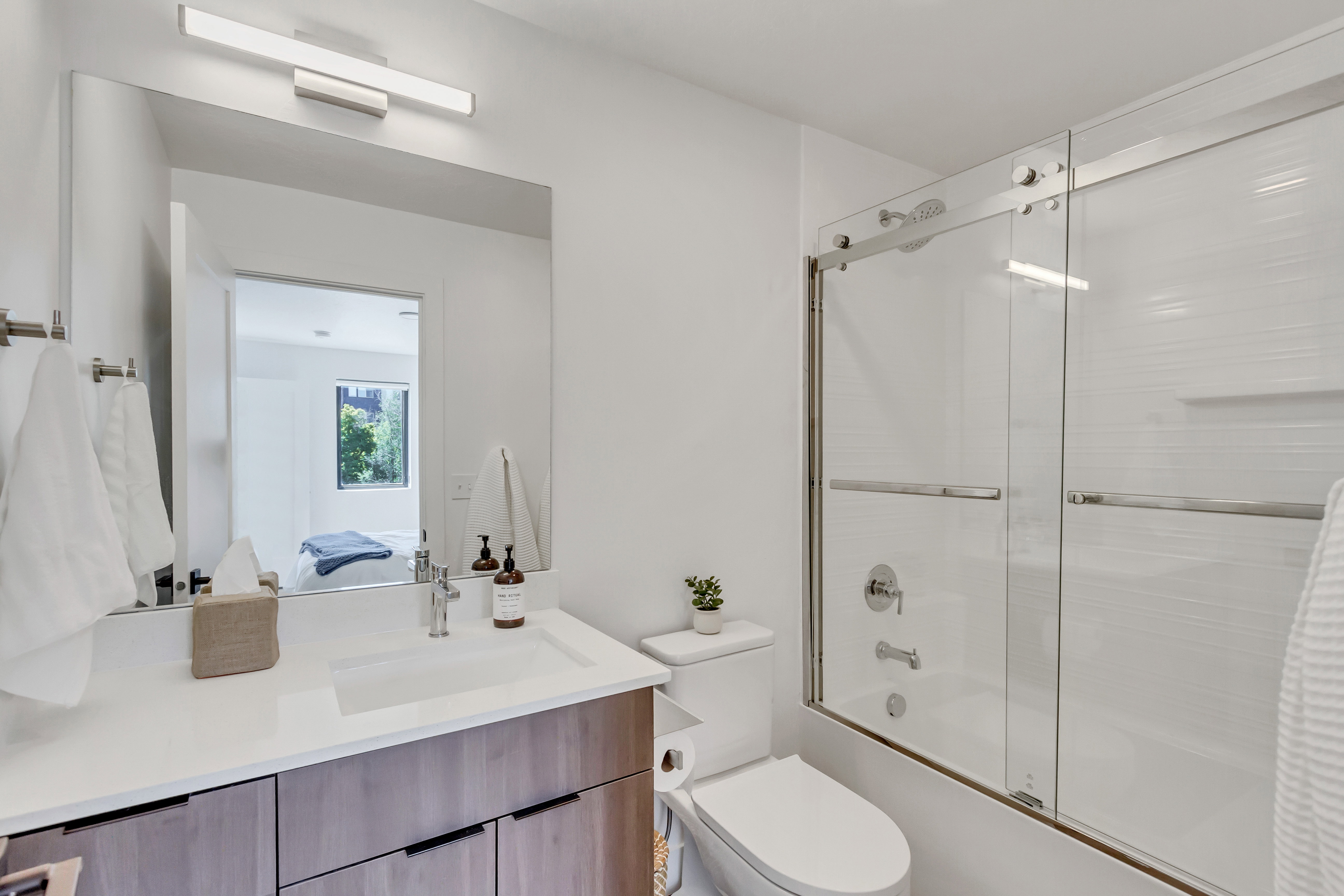 Ensuite bathroom with bath / shower combo with glass door and vanity