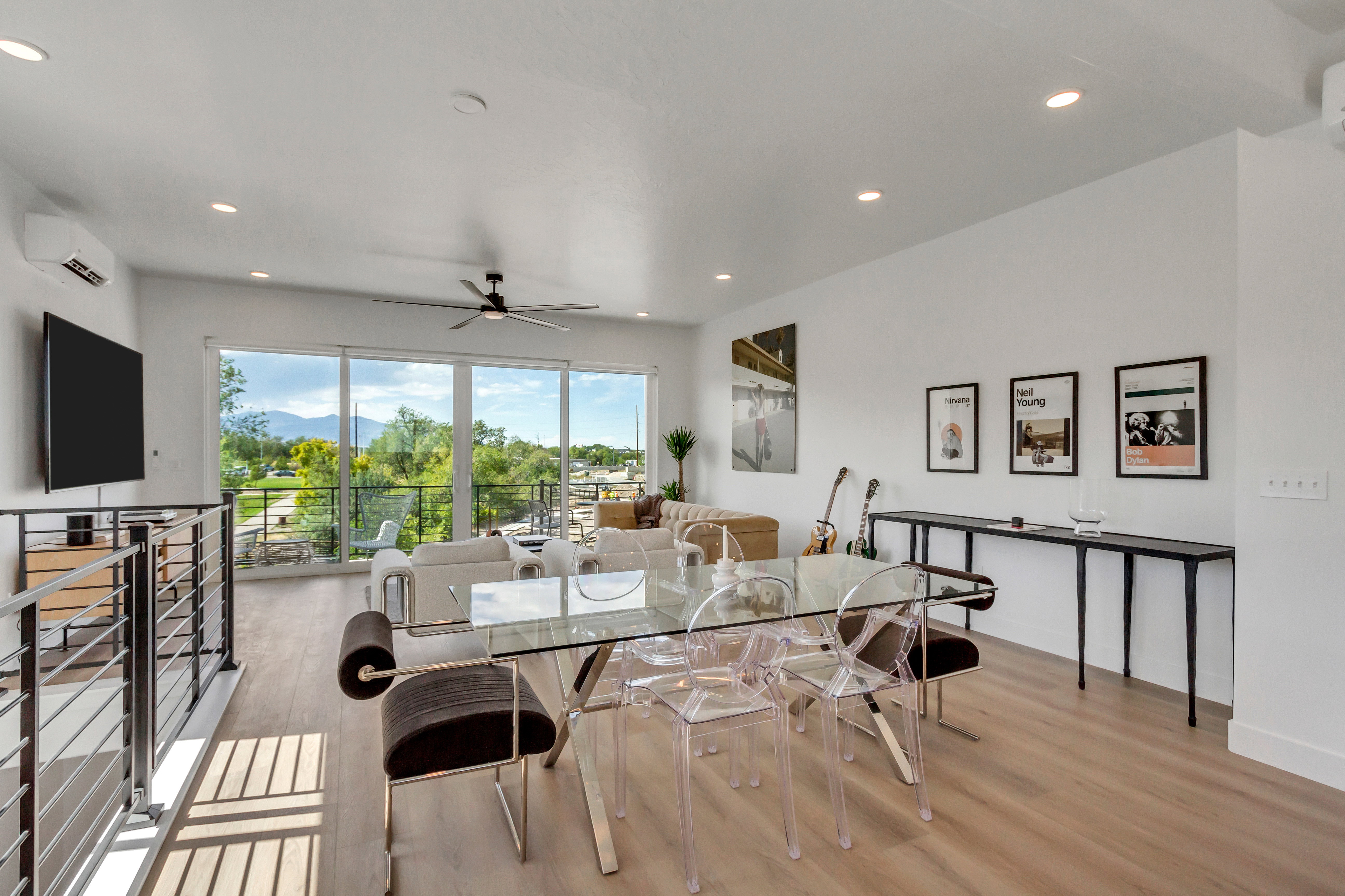 Dining room featuring light wood-type flooring, a ceiling fan, an AC wall unit, and recessed lighting