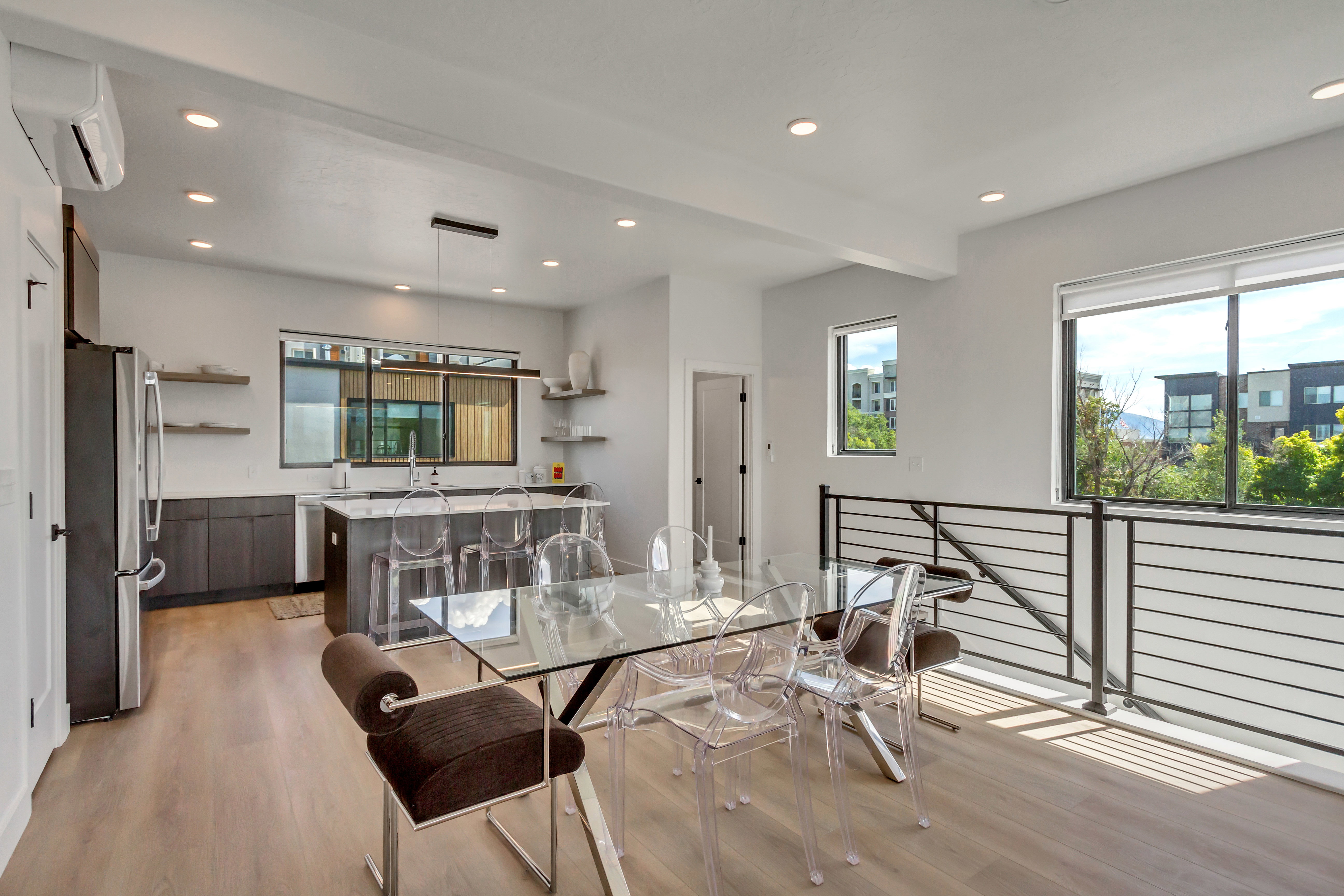 Dining area with healthy amount of natural light, a wall mounted air conditioner, light wood-style flooring, beam ceiling, and recessed lighting
