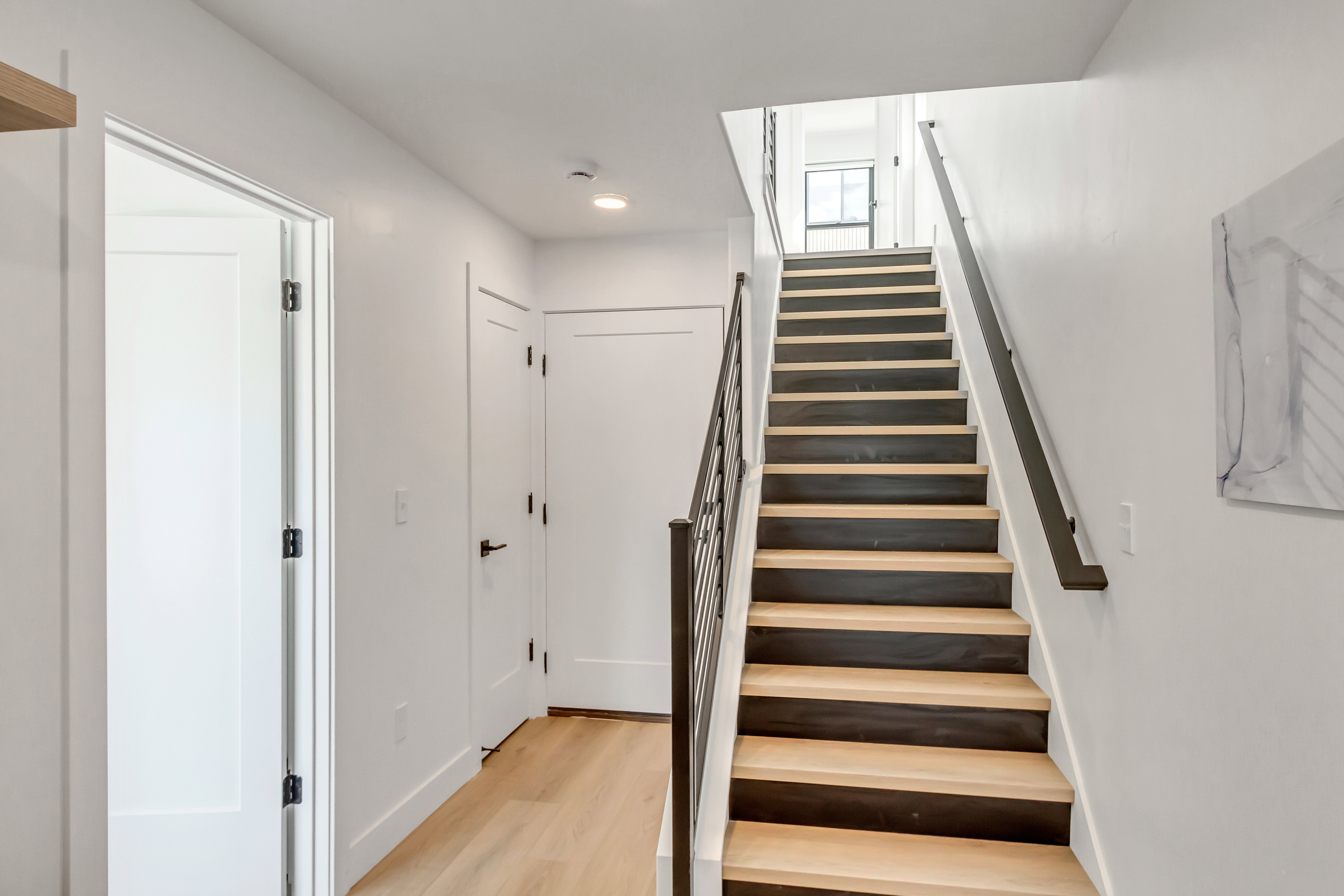 Stairs featuring wood finished floors and baseboards