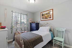Bedroom featuring carpet flooring and baseboards