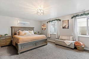 Bedroom with carpet and a textured ceiling