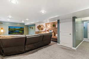 Living area featuring carpet floors and baseboards