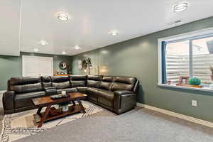 Carpeted living area with baseboards