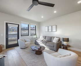 Living area featuring light wood-style floors and recessed lighting