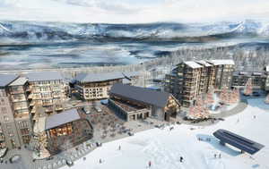 Snowy aerial view with a view of apartment building / complex
