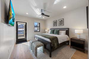 Bedroom featuring access to exterior, light wood-type flooring, ceiling fan, and recessed lighting