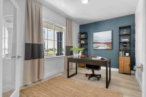 Office space with light wood finished floors and baseboards