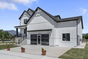 View of building exterior featuring a mountain view, concrete driveway, and stairway