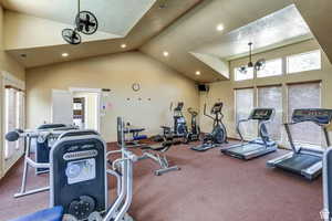 Exercise room featuring high vaulted ceiling and recessed lighting