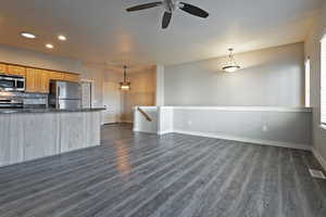 Kitchen featuring appliances with stainless steel finishes, recessed lighting, open floor plan, tasteful backsplash, and pendant lighting