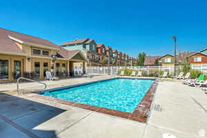 Community pool with a patio area, a residential view, and french doors