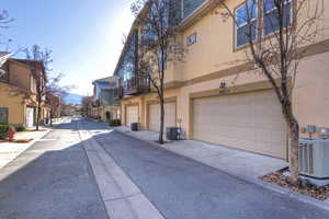 View of asphalt alley with a residential view and curbs