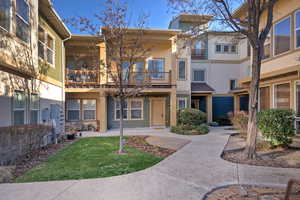 Surrounding community featuring a balcony and a lawn