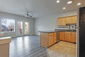Kitchen with appliances with stainless steel finishes, tasteful backsplash, open floor plan, a peninsula, and recessed lighting