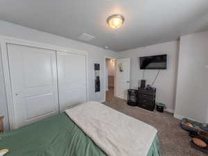 Bedroom with carpet and a closet