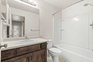 Full bath with vanity, shower / bath combination, and light tile patterned floors