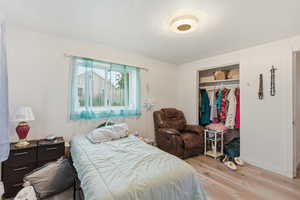 Bedroom featuring a closet and light wood finished floors