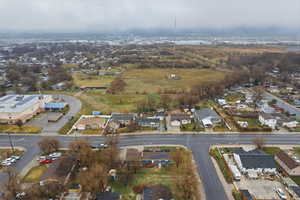 Aerial view of property's location with nearby suburban area