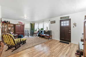 Foyer with light wood-type flooring and baseboards