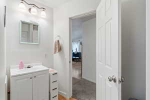 Bathroom featuring vanity and light wood finished floors