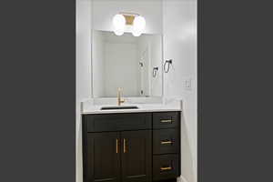 Bathroom featuring vanity and baseboards