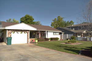 View of front of home with driveway and an attached garage