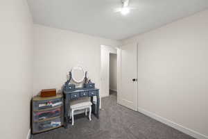 Office space with carpet and a textured ceiling