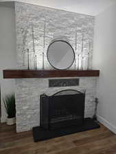 Detailed view of a fireplace and wood finished floors