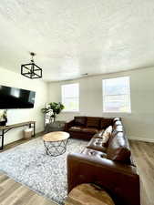Living area with light wood-style flooring and a textured ceiling