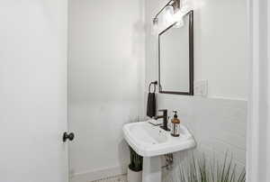 Bathroom featuring tile walls and a wainscoted wall