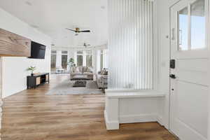 Foyer entrance with light wood-type flooring and a ceiling fan