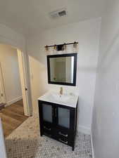 Bathroom with vanity and baseboards