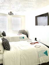 Bedroom featuring a textured ceiling