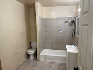 Bathroom with vanity, light tile patterned floors, and shower / bathtub combination