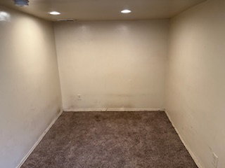 Empty room featuring carpet floors and recessed lighting