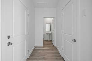 Hall with light wood-style flooring and a sink