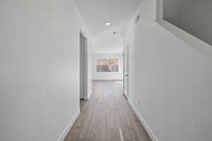 Corridor with baseboards and light wood-type flooring