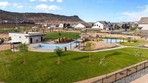 View of community with a patio, a residential view, a swimming pool, and a mountain view