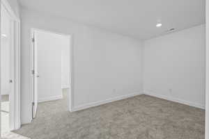 Unfurnished room featuring light colored carpet and recessed lighting