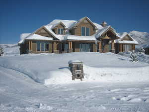 View of front facade with a chimney and a porch