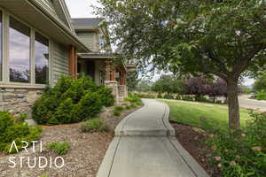 View of community with a yard and covered porch
