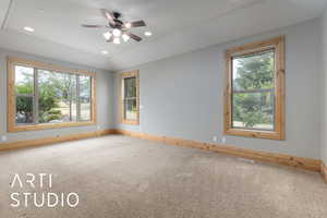Carpeted empty room featuring recessed lighting, lofted ceiling, and ceiling fan