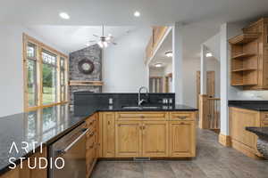 Kitchen featuring open shelves, dishwasher, dark stone counters, ceiling fan, and vaulted ceiling