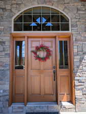 Doorway to property featuring stone siding