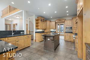Kitchen featuring open shelves, recessed lighting, a kitchen island with sink, glass insert cabinets, and stainless steel appliances