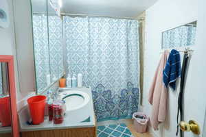 Full bath featuring vanity and wood finished floors