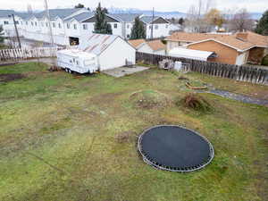 Fenced backyard featuring a residential view and a patio area