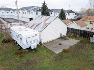 Back of house with a residential view, a fenced backyard, and a patio